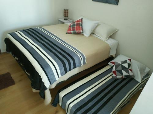 two beds sitting next to each other in a room at Edificio Paradisíaco,Cochabamba in Cochabamba