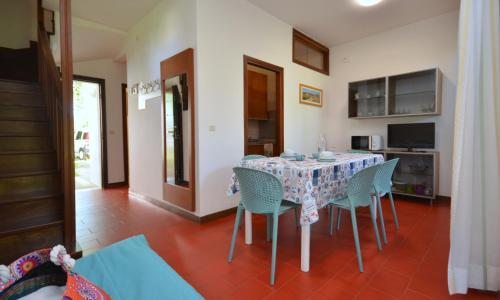 a dining room with a table and chairs at Villaggio Marina in Bibione