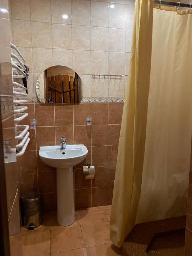 a bathroom with a sink and a shower at Oksamit Resort in Vorokhta