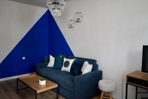 a blue couch in a living room with a blue accent wall at Brio boutique hotel in Velingrad