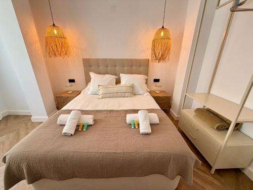 a bedroom with a large bed with towels on it at Moraira Castle Boutique Apartment in Moraira