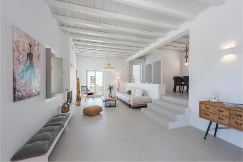 a white living room with a couch and a table at Luxury Complex Ninemia Villas in Faros