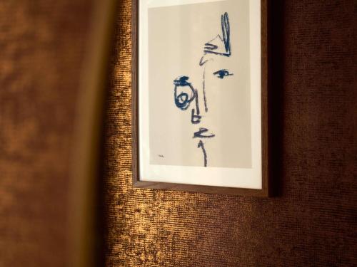 a framed drawing on a wall in a room at Hotel Morris Sydney, Handwritten Collection in Sydney