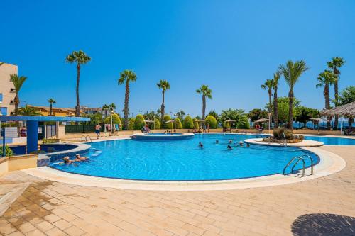 a pool at a resort with people in it at Aguamarina 2 Sunrise in Orihuela
