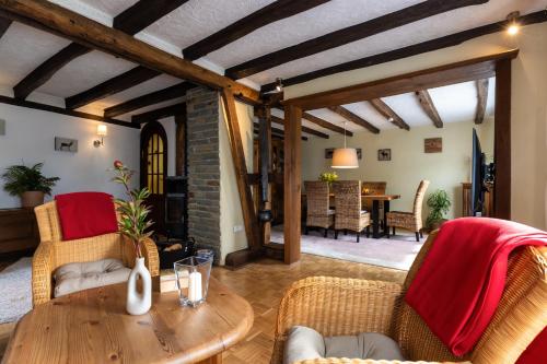 a living room with a wooden table and chairs at Ferienhaus Rosa in Mechernich