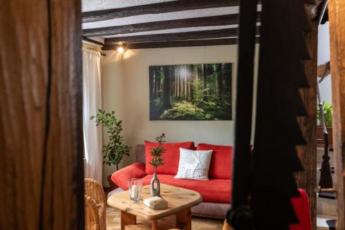 a living room with a red couch and a table at Ferienhaus Rosa in Mechernich