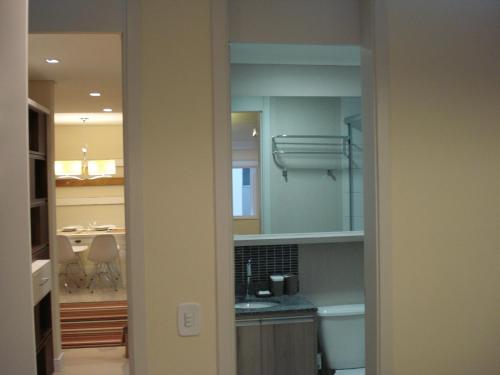 a kitchen with a sink and a counter top at Apartamento Aeroporto in Porto Alegre