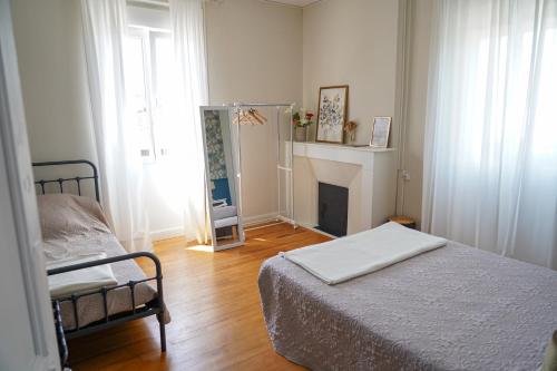 a small bedroom with a bed and a fireplace at Maison Hormidas in Crouseilles