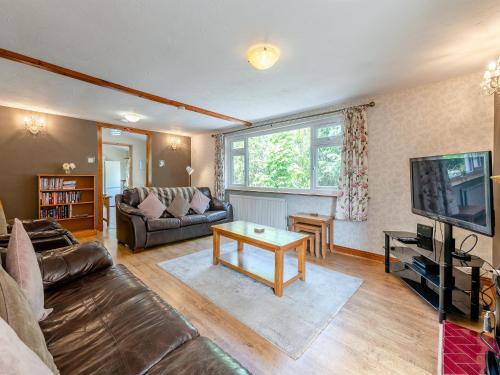 a living room with a couch and a television at Captains Quarters - 16266 in Staithes