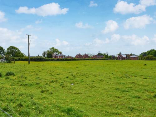 a field of green grass with houses in the background at Ivy - Uk47373 in Burgh le Marsh