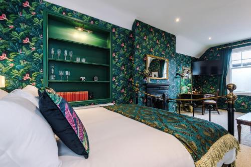 a bedroom with a bed with a green wall at Godstall Lane Boutique Accommodation in Chester