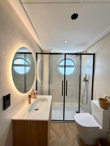a bathroom with a shower and a toilet and a sink at Moraira Castle Boutique Apartment in Moraira
