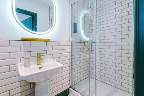 a white bathroom with a sink and a shower at Godstall Lane Boutique Accommodation in Chester