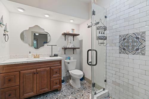 a bathroom with a sink and a toilet and a shower at Sandy Turtle-Gone to the Beach Be Back Never in Galveston
