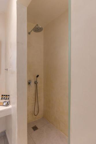 a bathroom with a shower with a shower head at Casa Philippi Suites in Mikonos
