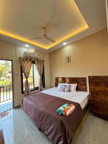 a bedroom with a large bed and a window at Satvik Homestay in Devgarh