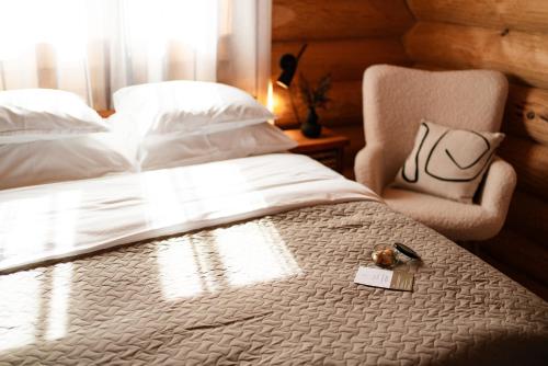 a bedroom with a white bed and a chair at Toosikannu Nature Resort & Hotel in Käru