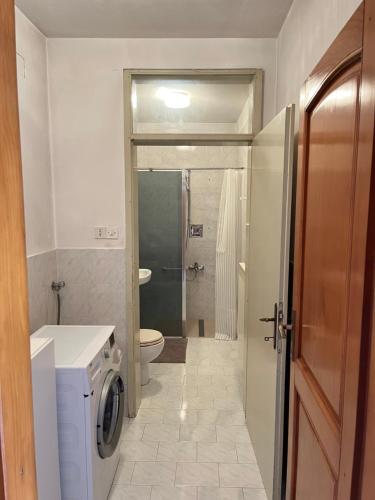 a bathroom with a washing machine and a toilet at Apartma Danijela in Kanal