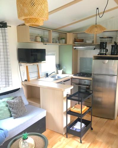 a kitchen with a stove and a counter top at Tentes Glamping au camping Le Gerrit à Marsous in Arrens-Marsous