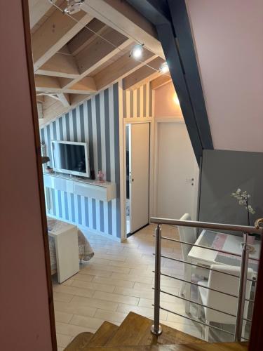 a living room with a staircase and a tv at Storico in Como