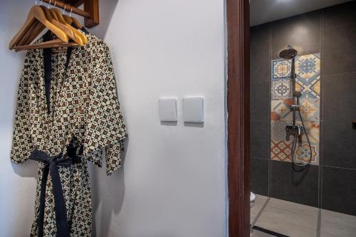 a room with a closet with a robe hanging on a wall at Soulstar Villa Ubud in Ubud