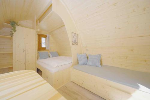 a small room with two beds in a tiny house at Traumhafter POD-M mit Seesicht - mit Terrasse aber ohne privates WC in Alpnach