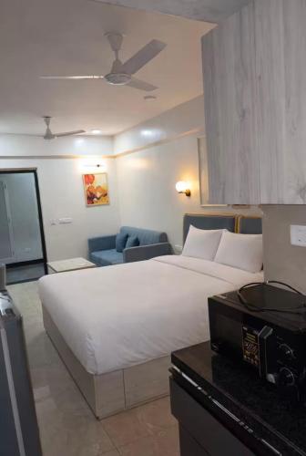 a hotel room with a large white bed and a desk at Belle Vue Stays in Jaipur