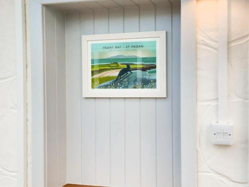 a framed picture of a beach on a wall at Drumwherry By The Sea in Monreith