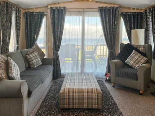 a living room with two couches and a window at Millars Caravan in Ayr
