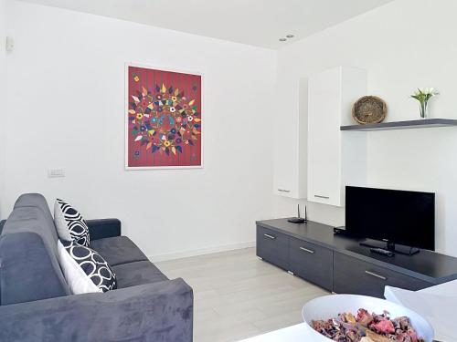 a living room with a couch and a tv at Apartment Titti - GLA133 by Interhome in Gera Lario