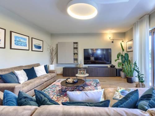 a living room with a couch and a tv at Holiday Home Sara by Interhome in Tar