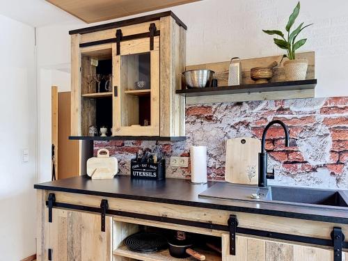 a kitchen with a counter top and a sink at Apartment Eifelhome Two nahe Nürburgring by Interhome in Fuchshofen