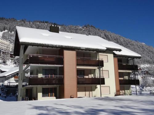 a apartment building with snow on the roof at Apartment Blumenweg 8 by Interhome in Engelberg
