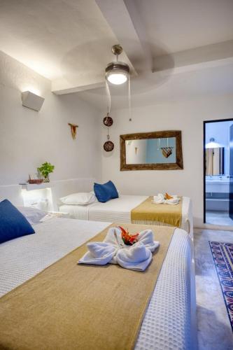 a hotel room with two beds with towels on them at Kin Ha Tulum Hotel in Tulum