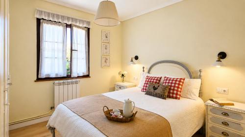 a bedroom with a bed with a basket on it at La Venta de Pedro in Ribadesella
