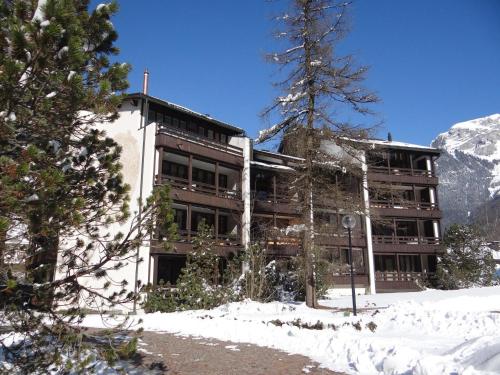 a building in the snow in front of a mountain at Apartment Am Dürrbach 5-545 by Interhome in Engelberg