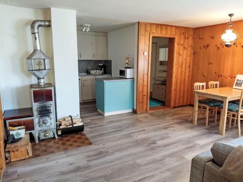 a kitchen and living room with a woodburning stove at Apartment Ritz by Interhome in Ernen