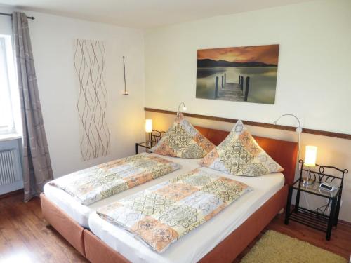 a bedroom with two beds and a painting on the wall at Apartment Panorama by Interhome in Berghofen