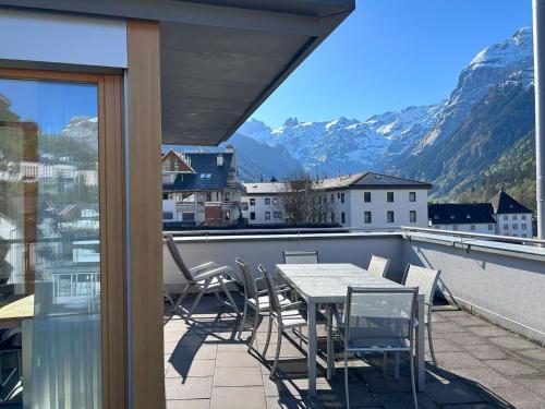 a patio with a table and chairs on a balcony at Apartment Dorfstrasse 7-42 by Interhome in Engelberg