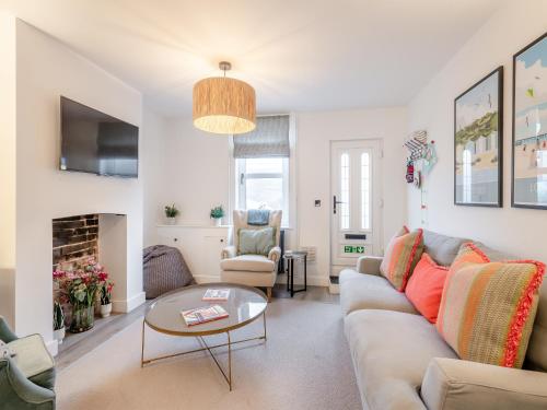 a living room with a couch and a table at Big Skies in Lowestoft