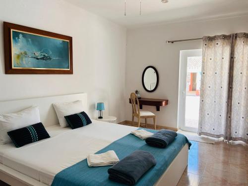 a bedroom with a bed with two pillows on it at Villa Madeira in Silves