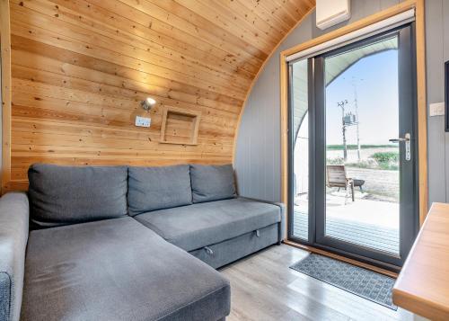 a living room with a couch and a sliding glass door at South View Retreat in Carlton