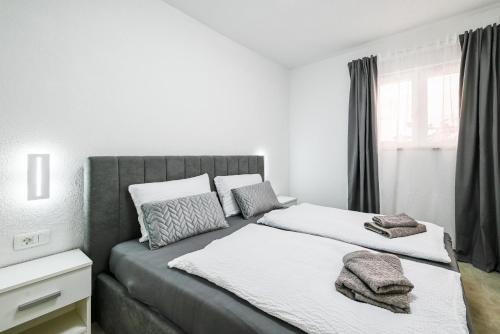 a bedroom with two beds with towels on them at Gasparevic Apartments in Rovinj