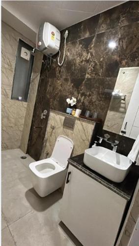a bathroom with a toilet and a sink at 12 Summits Elite Stays in Dehradun