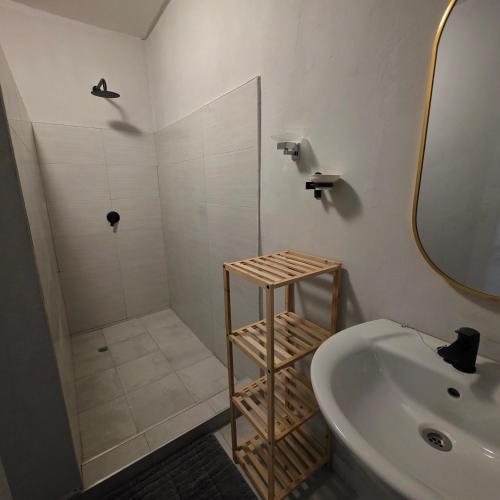 a bathroom with a shower and a sink and a mirror at Fully Furnished Apartments in Manyama, Lumwana Mine in Chanamo