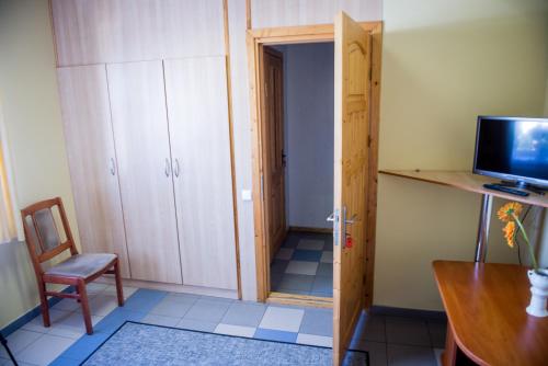 a small room with a door and a chair and a desk at Eiva in Marijampolė