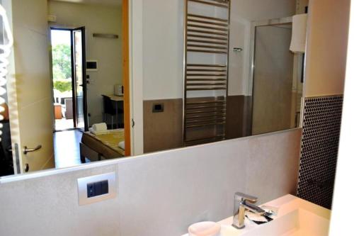a bathroom with a sink and a large mirror at Tenuta Espada Gallipoli in Gallipoli