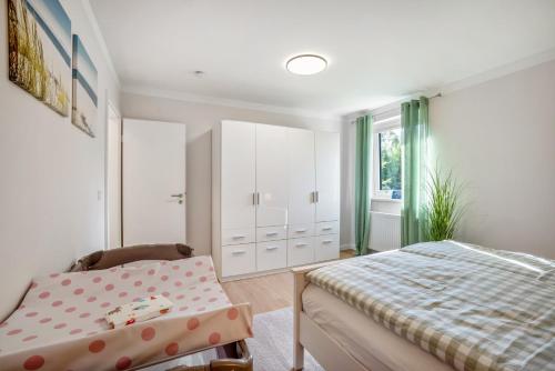 a bedroom with a bed and a chair in it at Ferienwohnung Nordic Stay Bäk in Bäk
