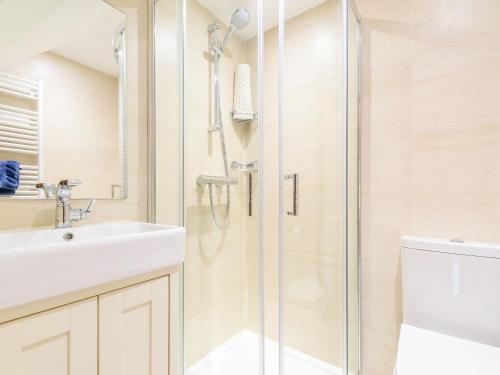 a bathroom with a shower and a sink and a toilet at Town Head Cottage in Carlton