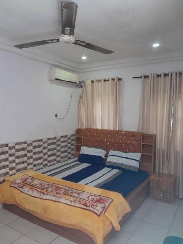 a bedroom with a bed and a ceiling at St Nicholas Guest Inn in Galadima